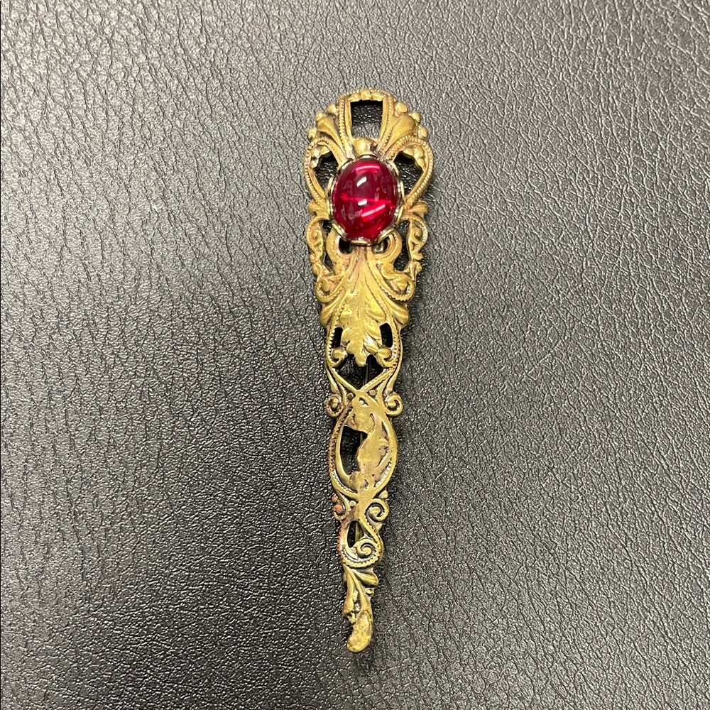 Filigree gold toned, brooch pin with red stone